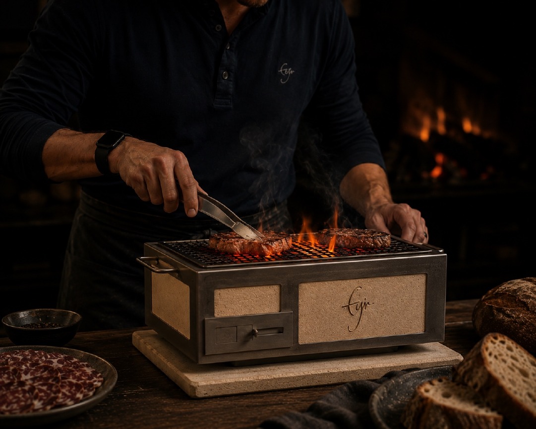 Cooking over a grill with bread nearby.